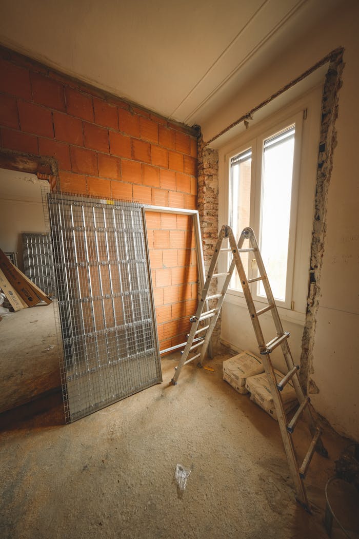 about-img An indoor space showing ongoing refurbishment with ladders and construction materials.